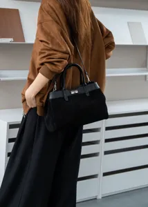 Elegant black suede top handle bag with turn-lock closure for women, chic shoulder crossbody.