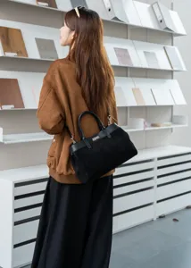 Black suede leather Kelly style handbag, elegant tote shoulder bag with top handle and metal lock.