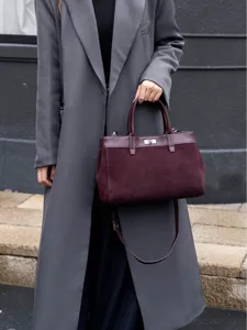 Elegant burgundy suede handbag with top handle and metal turn-lock closure for daily styling.