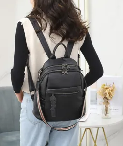Women casual black leather backpack detail view showing multi pockets and design.