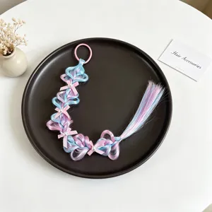 Vue détaillée de la perruque colorée pour enfants tressée avec des nœuds mignons et des perles.
