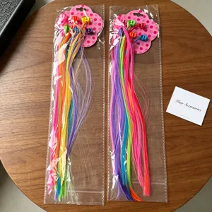 Close-up detail of colorful synthetic hair extensions with small claw clips in packaging.