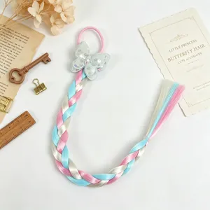 Detailed close-up of colorful braided hair extension with cute butterfly bow hair tie.