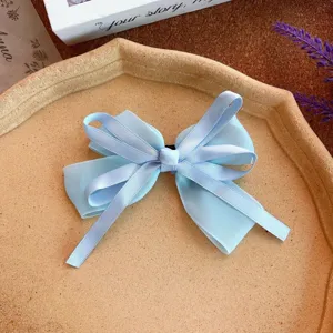 Sweet light blue ribbon hair bow spring clip for women and girls, elegant hair accessory.