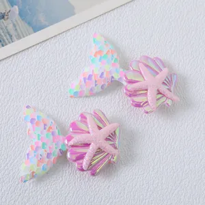 Mermaid tail sequin hair clip detail view, featuring seashell and starfish design for kids.