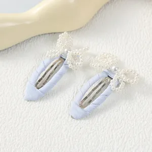 Bonitas horquillas de tela azul claro con lazos de perlas delicados para el peinado infantil.