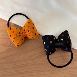 Korean style bow hair tie detail, colorful square pattern on orange and black fabric bands.