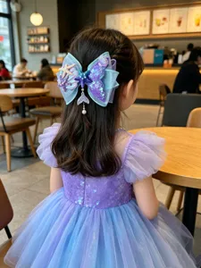 Detailed view of a charming mermaid hair bow clip with starfish and shell charms for girls.