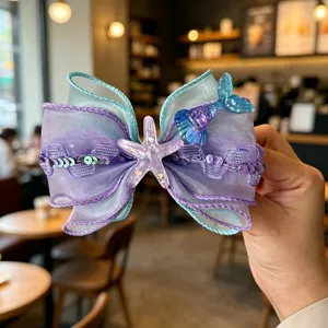 Children mermaid bow hair clip detail, purple organza sequin starfish design hair accessory.