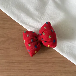 Korean style red fabric bow hair accessory detail, cute square pattern hair scrunchie.