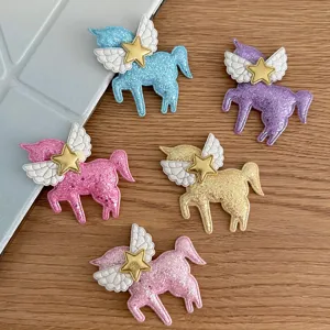 Glitter unicorn hair clips with angel wings and gold star, DIY craft accessories for kids.