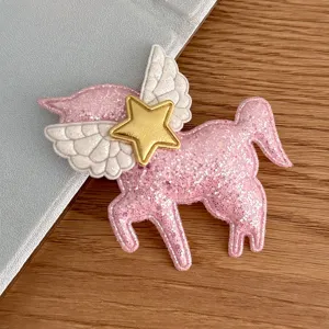 Details of the cute pink glitter unicorn patch with angel wings and gold star for DIY hair accessories.