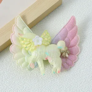 Close-up of glitter unicorn hair clip with sparkly angel wings and cute flower detail.