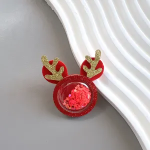 Detailed view of Christmas glitter reindeer hair clip accessory with floating star sequins.