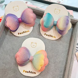 Affascinanti mollette per capelli con fiocco glitterato sfumato per bambini, con finitura brillante.