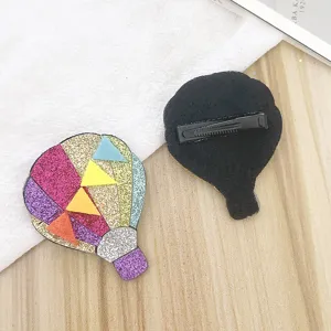 Close-up hot air balloon hair clip detail view, colorful glitter design with back alligator clip.