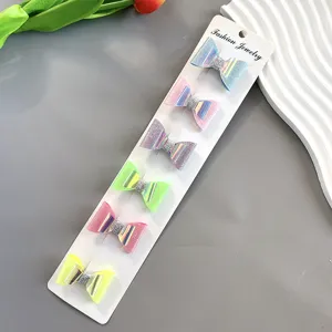 Detailed shot of colorful glitter bow hair clips set, sparkling handmade design for kids and girls.