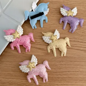 Cute cartoon unicorn hair clips with glitter finish, angel wings, and star charms for kids.