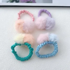 Detailed view of cute color-blocked fluffy pom-pom hair scrunchies for girls, soft and sweet.
