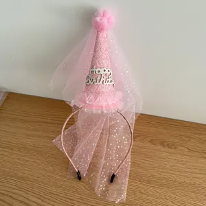 Pink birthday hat headband with mesh veil and glitter details for party decoration details