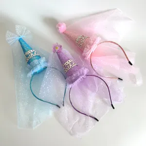 Close-up detail of children birthday cone hats with sparkling mesh veils and cute hairbands.