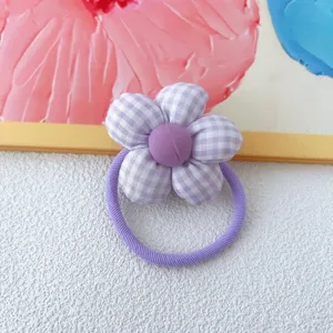 Purple gingham fabric flower hair tie detail shot, cute five petal scrunchie accessory.