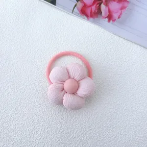Cute pink fabric flower hair tie for girls, soft floral hair scrunchie accessory.