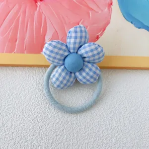 Detailed close-up of the blue gingham fabric flower hair tie, cute floral hair accessory.