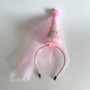 Close-up detail shot of pink birthday party mesh veil headband with cute cone hat design.