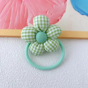 Green and white plaid stuffed flower hair tie detail close up view for daily cute hair styling