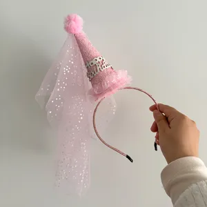Detail shot of the pink glitter birthday hat headband with starry mesh veil for kids party dress up.