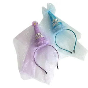 Close up details of children birthday party cone hat with mesh veil and headband decoration.