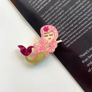 Glitter mermaid tail hair clip detail shot, cute pink and gold felt hair accessory for kids.