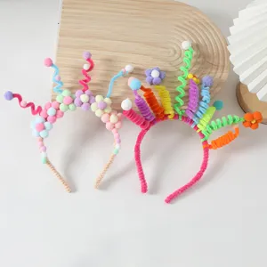 Close-up detail of colorful pipe cleaner flower headbands, DIY funny party hair accessories.