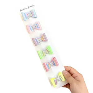 Glitter bow hair clips detail showcasing vibrant laser colors and neat card display.