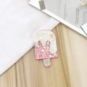 Glitter ice cream hair clip detail shot, featuring sparkling pink powder and cute rhinestones.