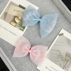 Cute polka dot mesh hair bow clip for girls, sweet fabric hair accessory for kids and babies.