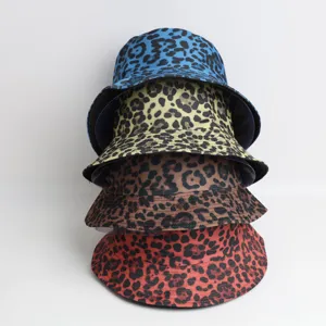 Detailed shot of stacked multi-color leopard print bucket hats, outdoor sun protection caps.