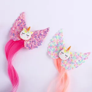 Detailed view of kids unicorn hair clips with colorful sequins and long bright hair extensions.