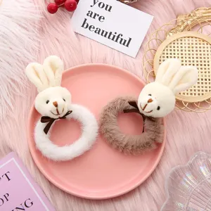 Detailed view of cute plush bear hair scrunchies with sweet bow knots and soft fuzzy texture.