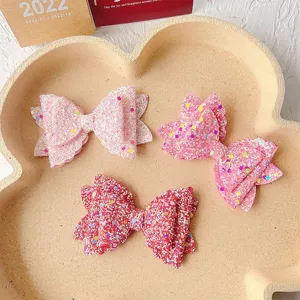 Glitter sequin bow hair clip detail shot, multi-layer cute pink hair accessories for kids.