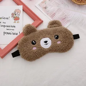Detailed view of cute cartoon bear plush sleep mask, soft teddy fleece shading eye cover for travel.