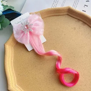 Cute kids pink bow hair clip with curly synthetic hair extension for party dressing.