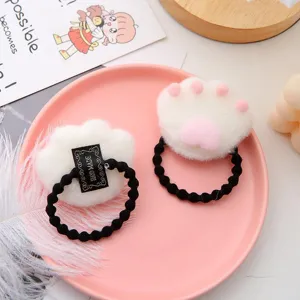 Cute plush cat paw hair rope with pink pads and black elastic band, soft texture detail view.