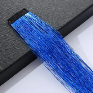 Close-up detail of blue shiny hair tinsel extension clip, sparkling metallic hair strand.