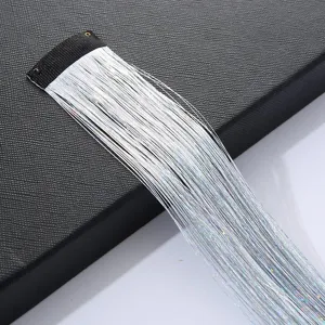 Detail shot of holographic hair tinsel extension with BB clip, sparkling metallic strands.