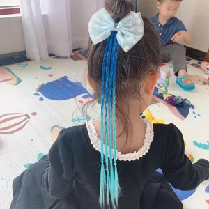Kids blue bow hair extension wig detail showing colorful braided ponytail hair accessory close up