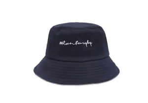 Close-up detail view of the navy blue cotton bucket hat featuring delicate white cursive embroidery.