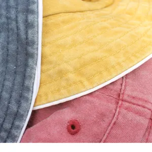 Detailed view of washed distressed bucket hat fabric, showing fine stitching and texture.
