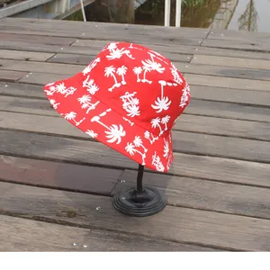 Red bucket hat with white palm tree print, stylish cotton casual hat for outdoor sun protection.